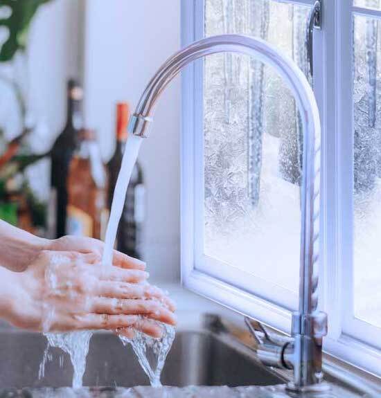 Woman washing hands using pressurized water